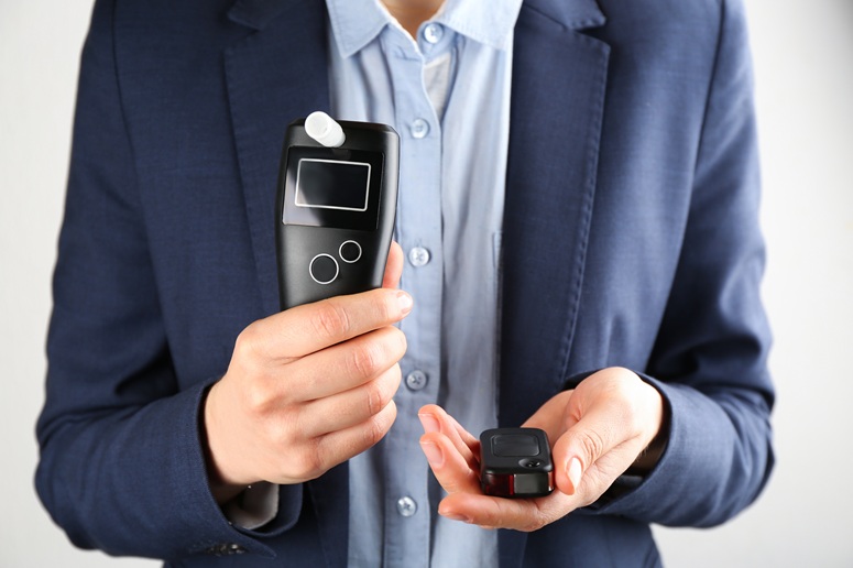 Man holding a breathalyzer