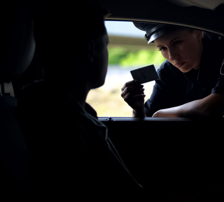 Police officer pulling someone over to start drug search.