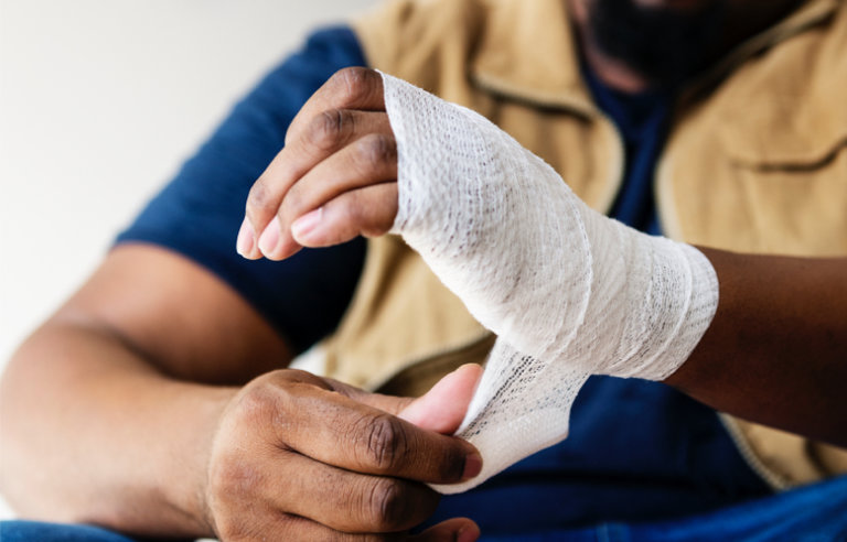 Person with injured hand that is bandaged.