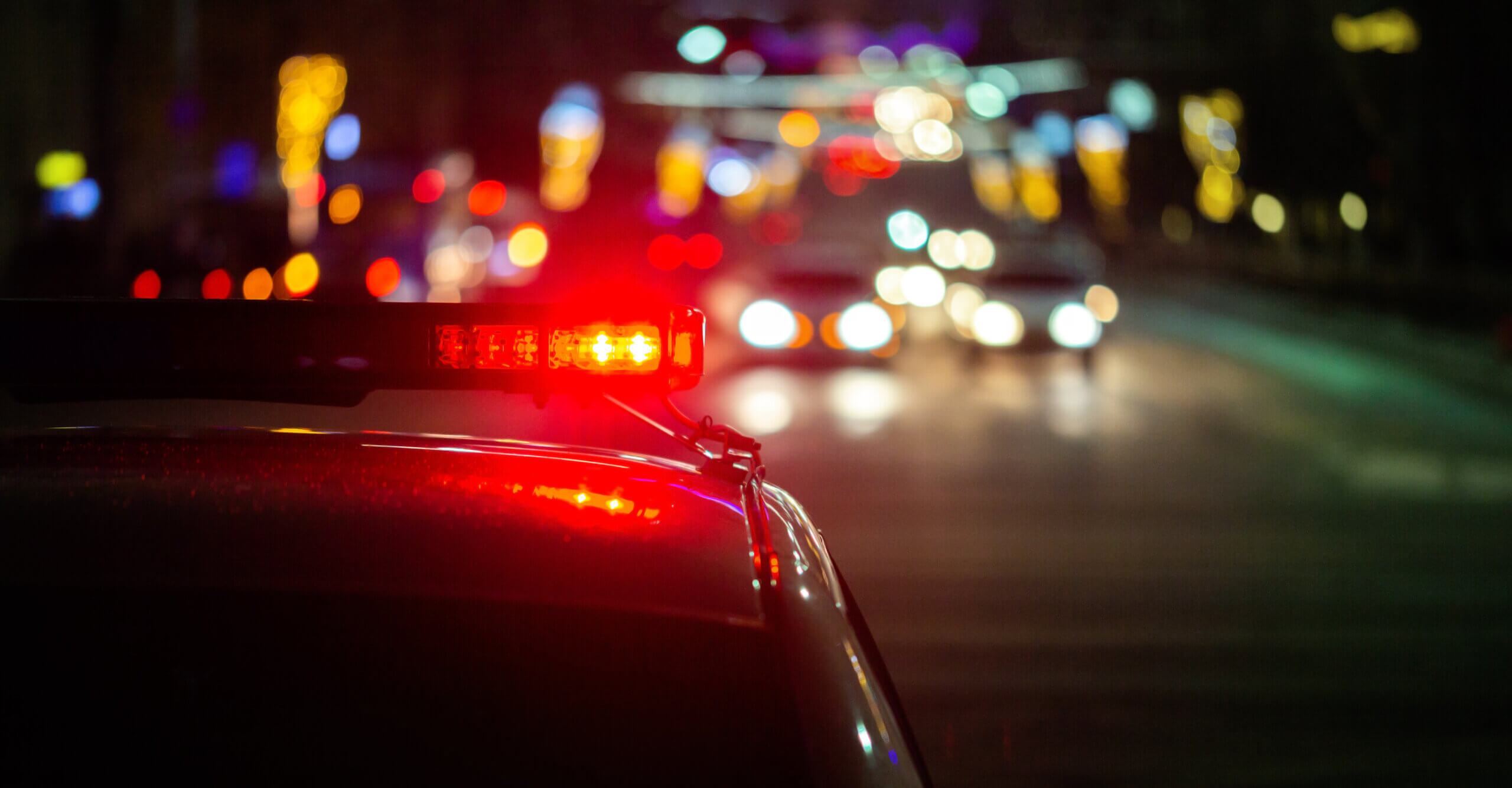 police car lights at night in city with selective focus and bokeh background blur