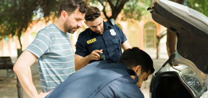 Police officers searching a car